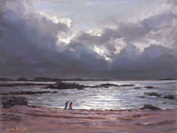 Two people on beach with storm clouds behind them