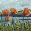 Poppies in grass beside the sea